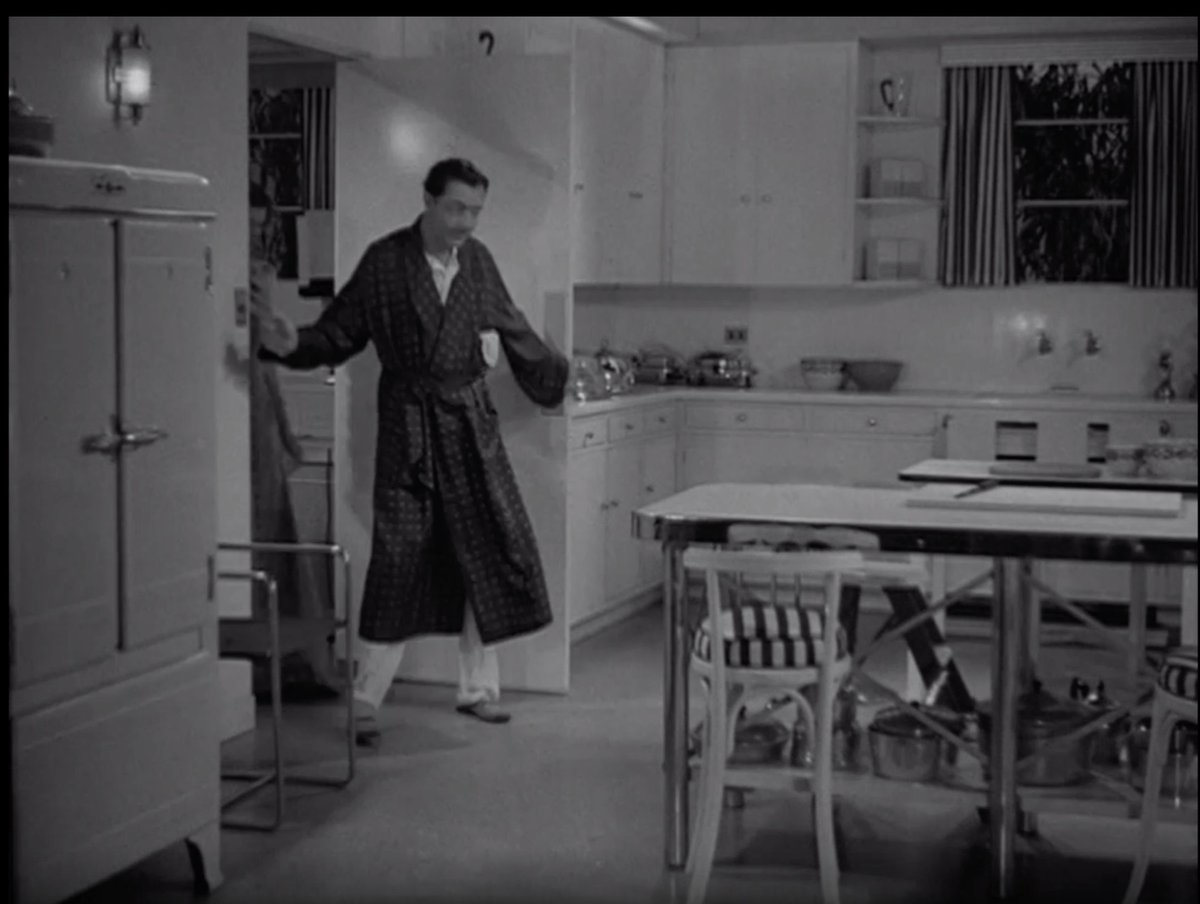 It's really rare to see a deco kitchen on film, so I always perk up whenever there's one on screen. I wish this was in color so bad - what do we think? Chiffon yellow? Robin's egg blue? Mint green? It has to be some kind of pastel. Love all of the chrome and then the fun stripes.