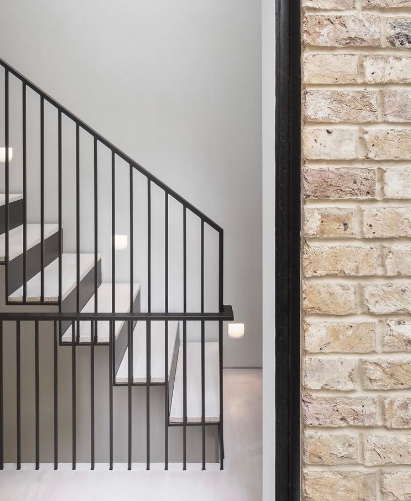 Pale Douglas Fir flooring and staircase boards elegantly juxtapose the delicate matte black metal work of this property by @maxwellandcompany.