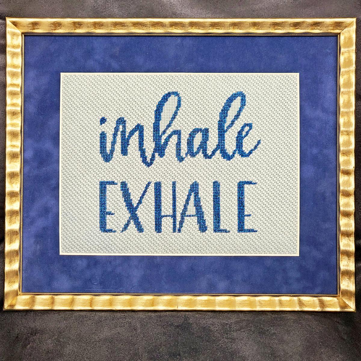 NeedleMe_Me's tweet photo. Happy Monday! Patricia S. stitched his "inhale exhale" canvas from @colors_of_praise_needlepoint and finished with a gold frame and blue suede mat. We love the blue metallic thread she chose for the lettering! https://t.co/RjOYoFCvY3
