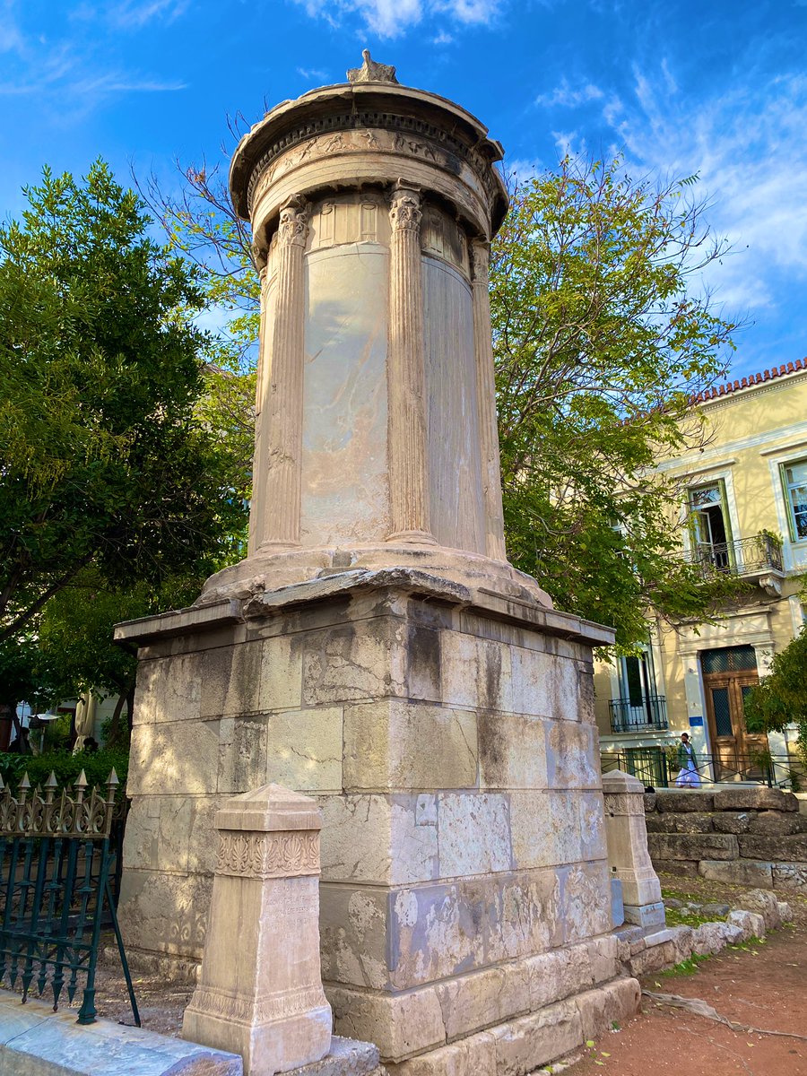 8/12 One of the most striking features of this monument is its contrasting marbles: yellow-white for the sculpture from Mt. Pentelikon atop a base of grey marble from Hymettus!The same technique is seen with the alternating plaques & columns on the nearby Lysikrates monument!