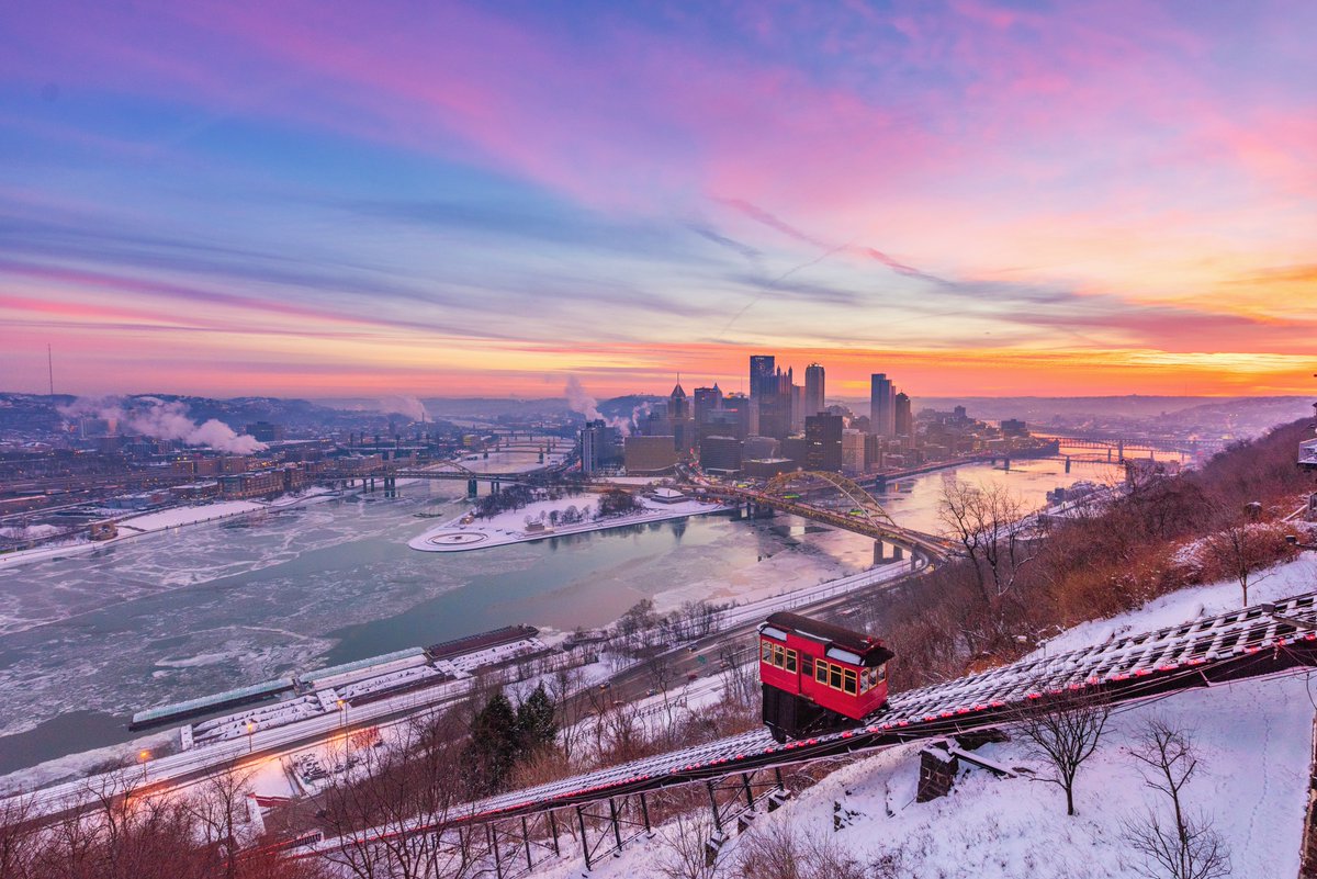 DaveDiCello's tweet photo. While I've shot snowy sunrises from the incline in #Pittsburgh many times, I've never been able to top the one that I captured 5 years ago today. A vibrant sunrise provided the backdrop for the city and icy rivers, with the red car popping against the fresh snow. What a morning. https://t.co/IVObBHKlLv