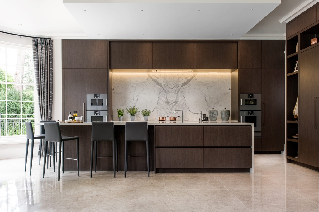 This is an example of a large contemporary kitchen in Surrey with flat-panel cabinets, dark wood cabinets, an island and white worktops.

#kitchendesign #kitchendecor #kitchen #cabinets #cabinetdesign #kitchencupboards #kitchenorganization #kitchencabinets #darkwoodcabinets