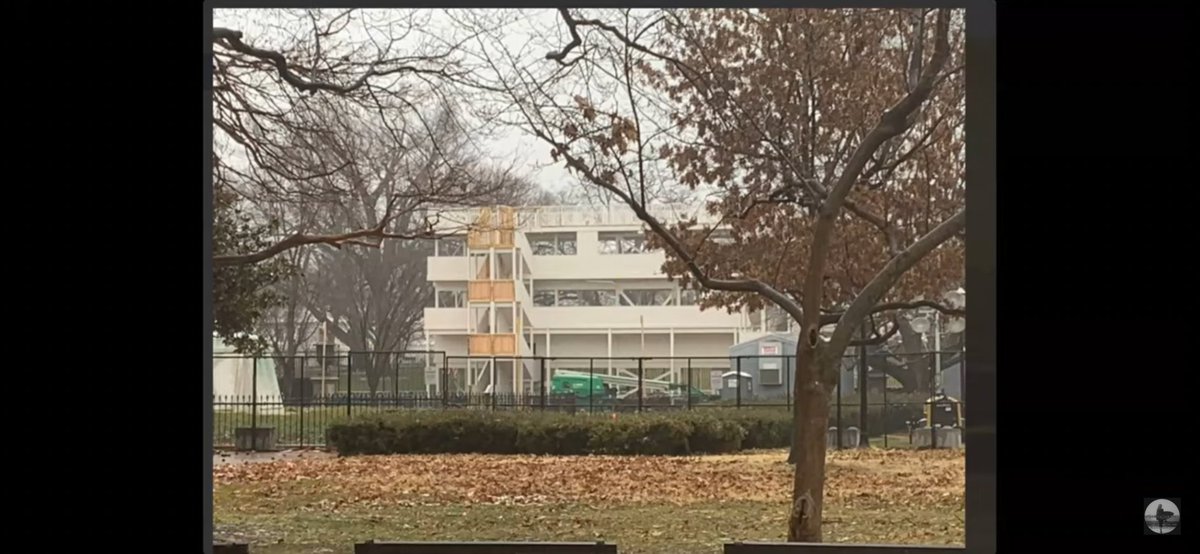 HamEggsnSam's tweet photo. This is the best picture so far of the WH tower. Looks like it may be primarily made of wood.

Has power (gray shack) to run the lights on the front. Are those bars on the bottom? There are "rooms" as at night I've seen lights only light up a small portion. https://t.co/8Ux5U12Duf