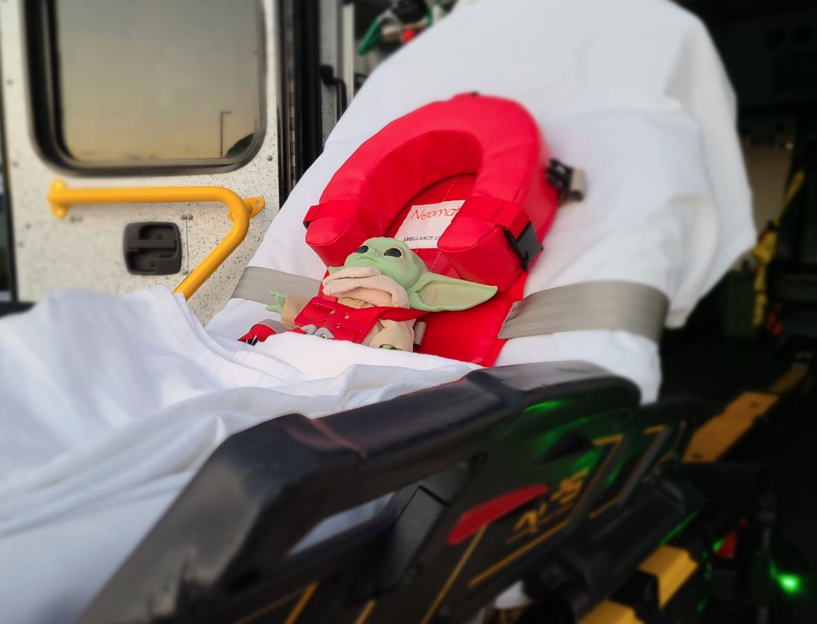 Once patients are in the transporting unit they stay secured during transport via seat-belts on the gurney or a car seat if they are a pediatric patient. Some agencies use a device such as the Neo-mate (pictured).