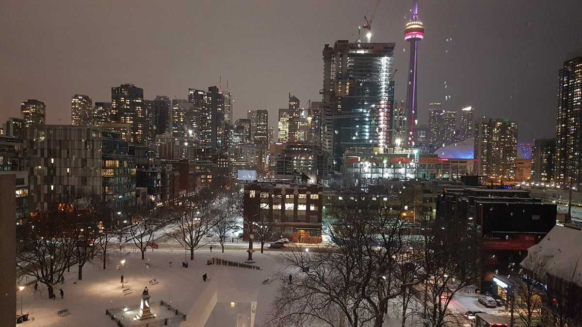 Thr city sparkles at night in the snow.