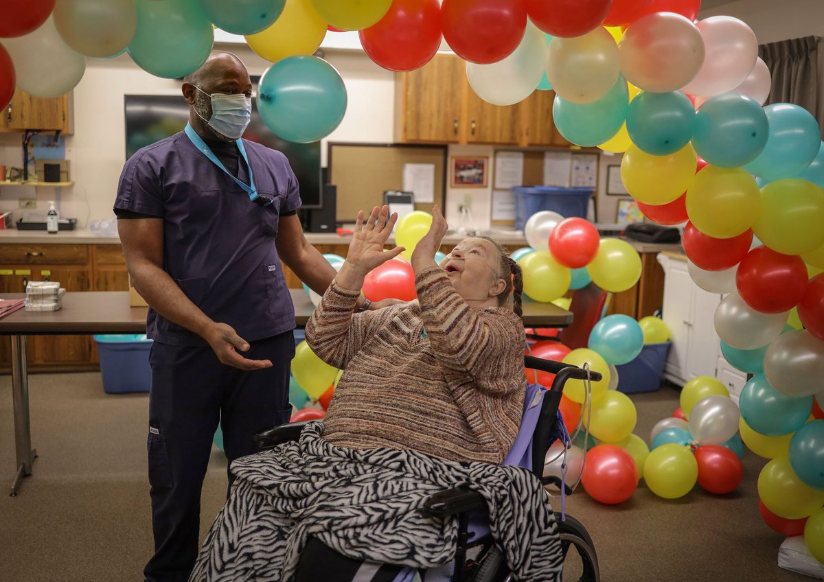 AHS_media's tweet photo. Joyce Adams has reason to celebrate—the 78-year-old Clifton Manor resident received her second dose of the #CovidVaccine this week. She shared a moment of joy with RN Emile Enongene, Director of Nursing at the manor. #ShotofHope https://t.co/W9FsjdkNEs