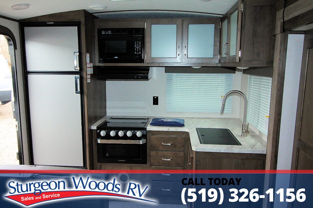 Check out the design on this Keystone Passport 2500RK...RK, for the Rear Kitchen. As part of the set up on this unit, cozy chairs to relax &amp; watch some TV, U-Shaped dinette &amp; even a desk to help keep you organized while on the road - here's a quick video: ow.ly/JcMN50DjFzm