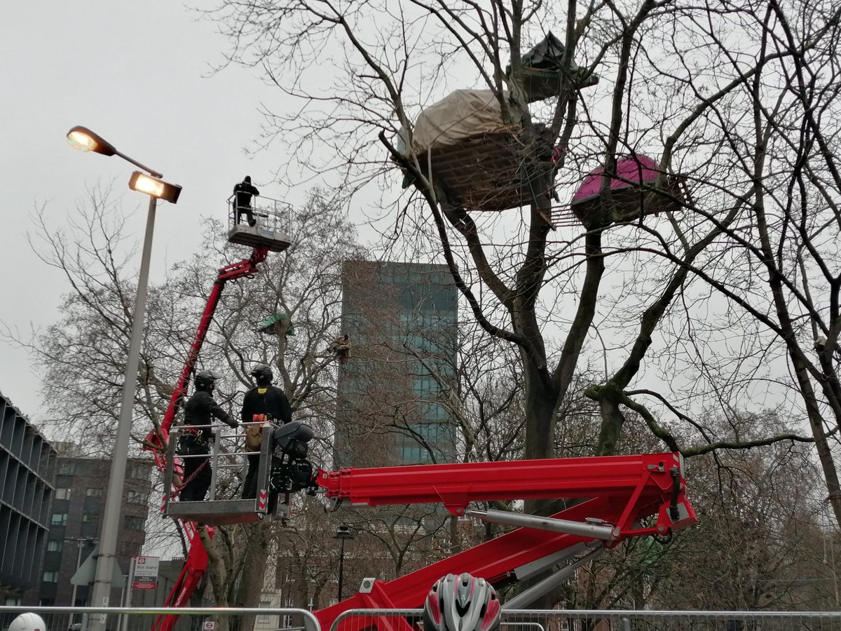 Cherry pickers with specialist N. E. T officers about to talk to protesters