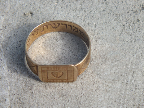 7/ >> 2 special items were found. A pendant with an engraving saying "Mazal Tov" (Congratulations in Hebrew), dated 3.7.1929 with the name Frankfurt am Main. The second is a wedding ring found outside the gas chambers with the Jewish marriage vow "You are consecrated to me". >>
