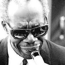 Professor Longhair with a piano reflected in his sunglasses.