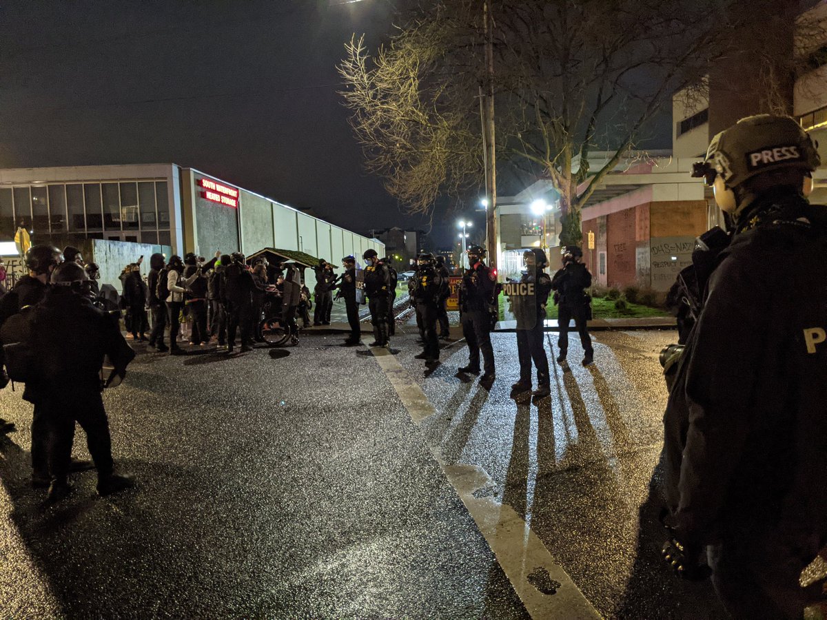 Shift change arrives. Line pushes protesters well back from the driveway. New standoffNot very many of them in the police line tonight