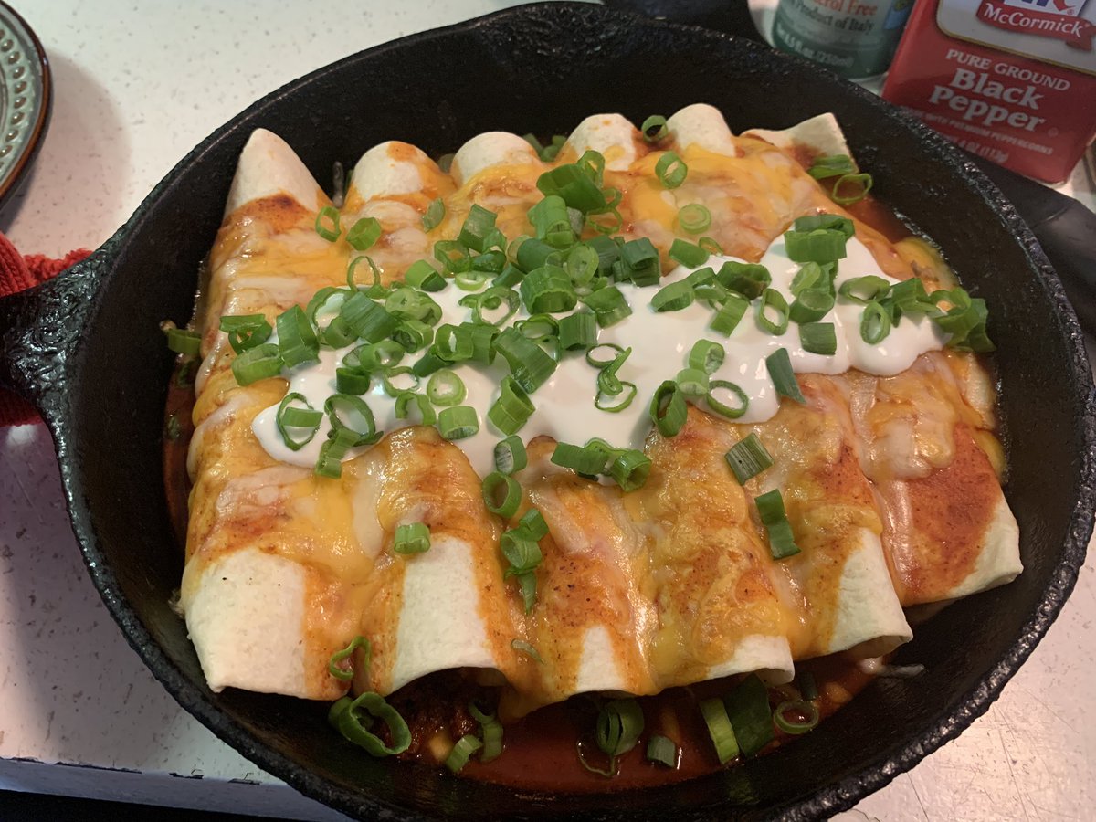 Delicious looking Plant-Based Protein Enchiladas with lime creme and scallions.