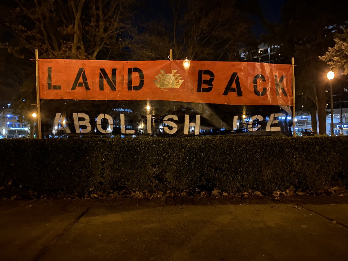A red and black banner has been erected. “LAND BACKABOLISH ICE “
