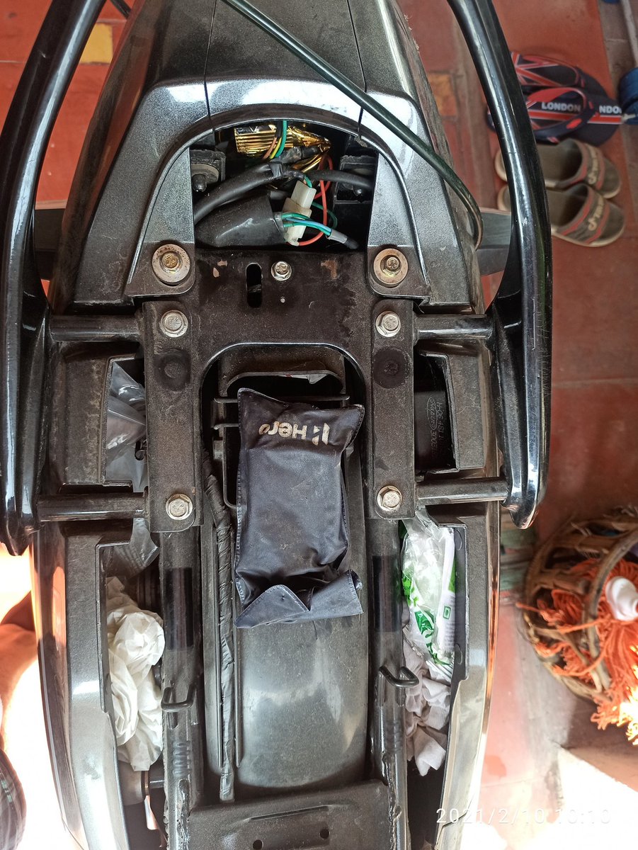 Open your seat, you'll find this Hero Cover which will have the tool to open the Spark Plug