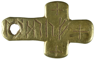 It's a solid gold Latin cross with crude piercing, prob a repair. The slight concavity on the top is all that remains of original attachment. The entire length is filled with an inscription comprising six runes & each arm has a single (crudely) incised equal armed cross