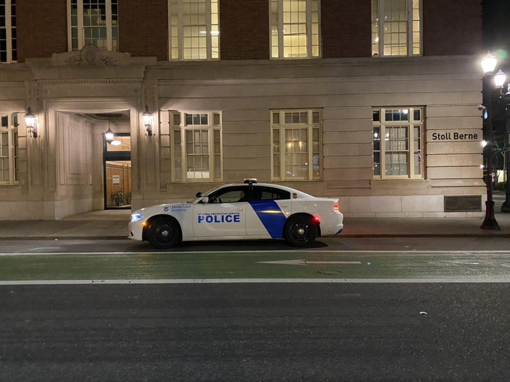 For reasons unknown, the department of homeland security has decided that it is prudent to have an officer posted up by the protest. Something about teenagers reciting poetry seems to threaten them?