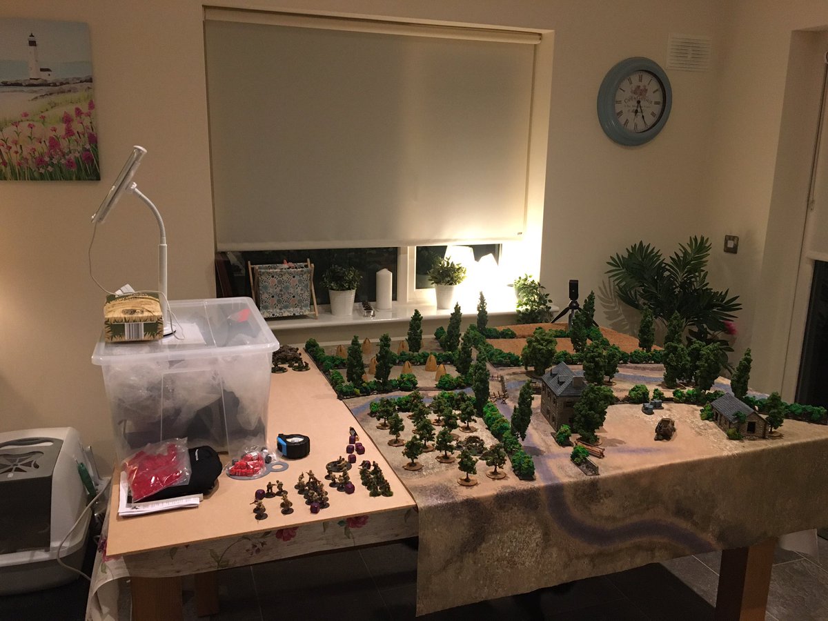 tomjmegan's tweet photo. Right so here’s the (temporary) set up. Aerial view camera provided by iPad, somewhat precariously positioned on the terrain box (until I get a proper stand). iPhone on tripod stand provides the battlefield tactical view which can be moved as needed. #virtualwargaming https://t.co/cnkbxH8UiF