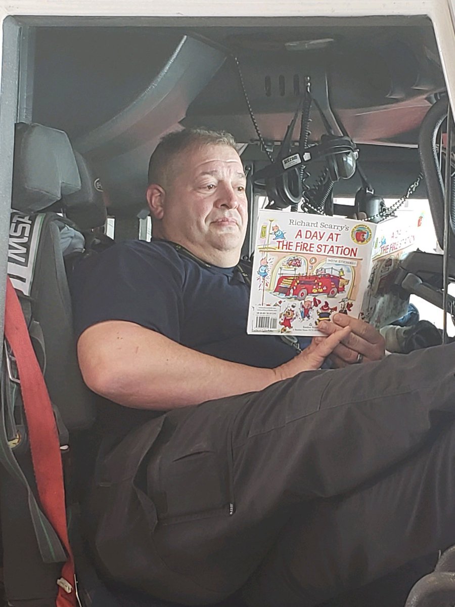 LNKFireRescue's tweet photo. Captain Stohlmann saw the book Chief Mueller was reading the crew and he snuck off to give it a read in the engine. 

{Reading challenge between the Cathedral Eagles and #LFR.}

#UpForTheChallenge #CanRead #LNK @CityOfLincoln https://t.co/NL8Vt7jgQi