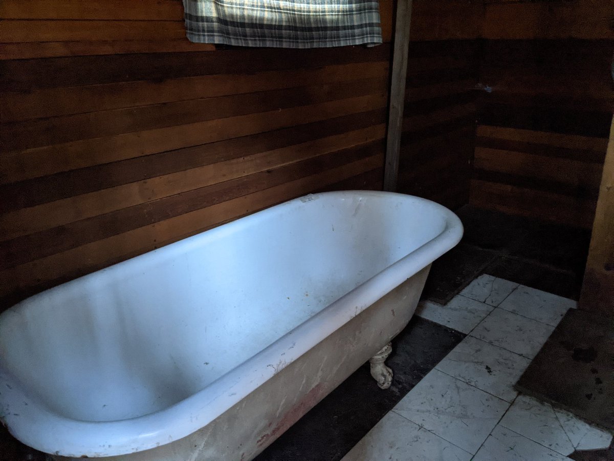 A bath house with a claw bathtub and shower, heated by propaneThe water tank costs the camp $400 a month, and it gives them drinking water and a way to bathe