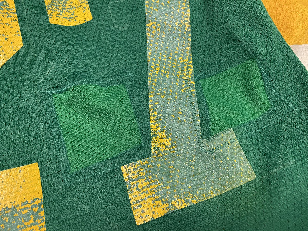 So what I did was graft some of the original fabric to where the holes in the 8 are, otherwise the original 7 would show through. I patched the holes with a lighter green fabric. When the 8 was sewn in place, it looks stock. I used chalk to mark the 8.