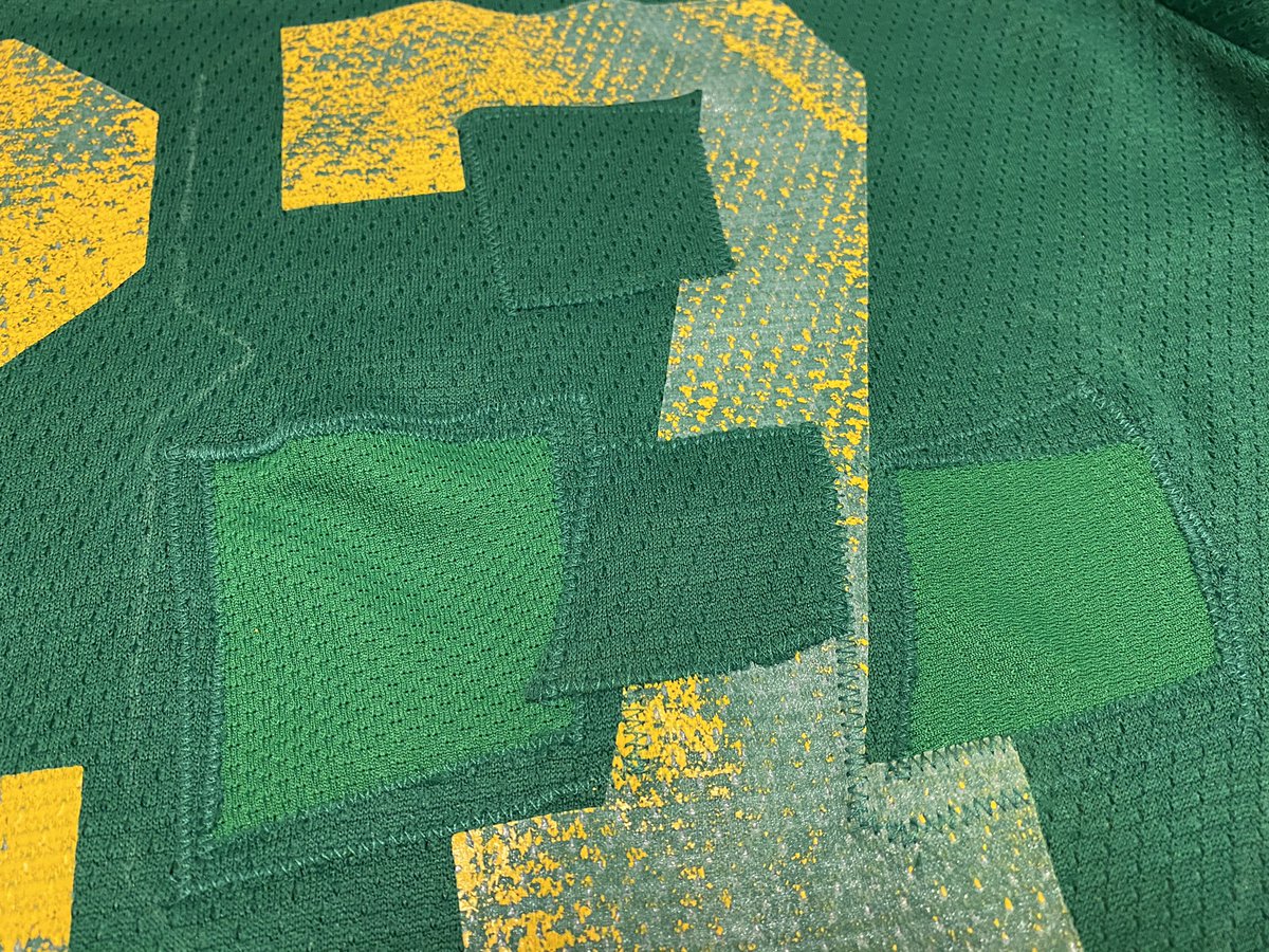 So what I did was graft some of the original fabric to where the holes in the 8 are, otherwise the original 7 would show through. I patched the holes with a lighter green fabric. When the 8 was sewn in place, it looks stock. I used chalk to mark the 8.