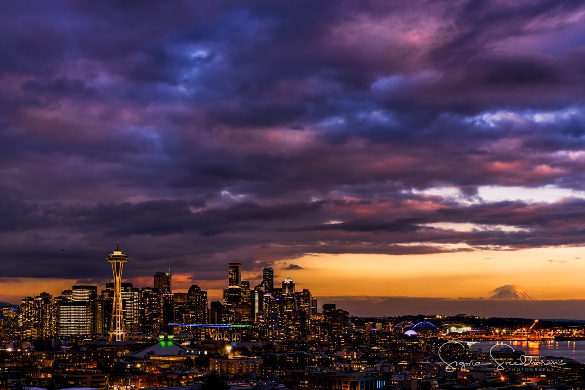 Another one from tonight. The little #lenticularcloud on #MountRainier and the drama clouds in the sky! I layered in a photo from later in the evening to light up the city.