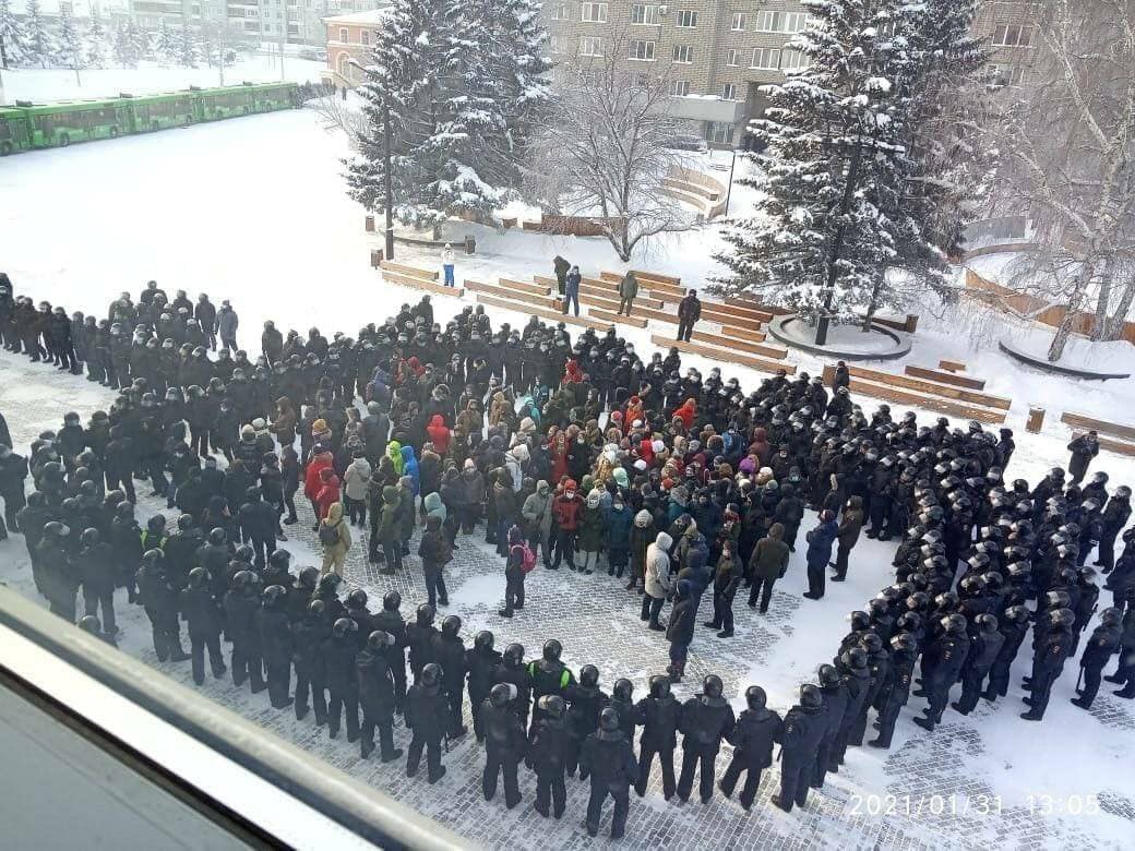 A photograph symbolic of the mood in Russia today:A small crowd of protesters in Krasnoyarsk, Siberia stands encircled by at least three times the number of riot police.