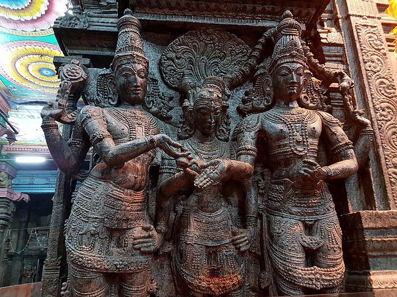 Mariage of God Shiva and Goddess Parvati (Meenakshi) witnessed by Lord Vishnu (left), He gives away his sister and bride Meenakshi's (Parvati) hand into the waiting hand of groom Sundareswar (Shiva) at the beautiful  #MeenakshiTemple, Madurai, India. #SanatanDharma 