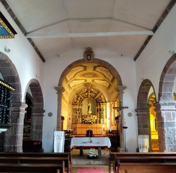  The chosen church in Santa Maria is Nossa Senhora da Purificação in the hamlet of Santo Espírito (pop. 588). It’s almost like something out of Hansel & Gretel, with a chessboard pattern on the belltower and a really elaborate basalt frontispiece.