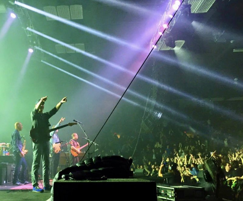 The light beam and cable bisect <a href="/umphreysmcgee/">Umphrey's McGee</a> and the audience, representing the division(s) between artist and viewer. However the two groups also reach towards each other, indicating a symbiotic relationship. Plus it’s a cool fucking picture.