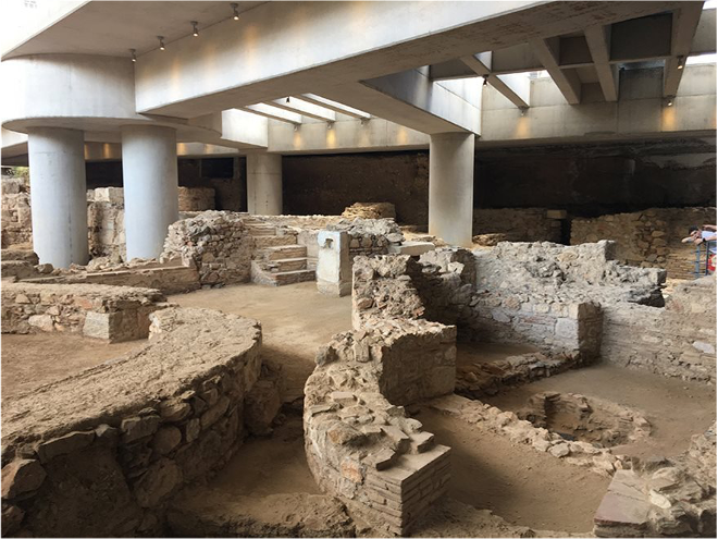 Building E featured a large reception hall w/ an apse. Next to this room was a triclinium, used by Building E's owner & friends for dinner gatherings. To the north sits a large circular structure resembling a tower. Around this were multiple smaller storerooms.