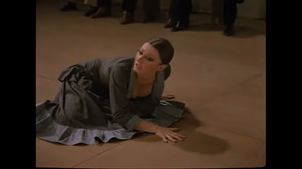 …Until she ends up on the floor … twice during the piece she tat-a-tat-tats on the floor at points of high drama. Here with her hand and later with her heels …