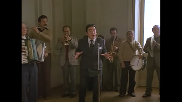 Next up, the wedding scene (my favourite). The singer at the wedding appears to be Silvio Bellusconi – he’s hilarious. And he’s being accompanied by Sadam Hussein on the left …
