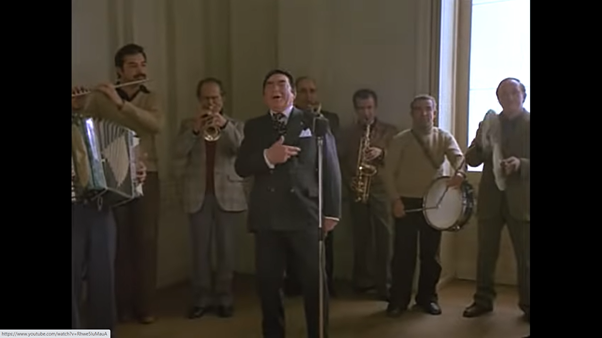 Next up, the wedding scene (my favourite). The singer at the wedding appears to be Silvio Bellusconi – he’s hilarious. And he’s being accompanied by Sadam Hussein on the left …