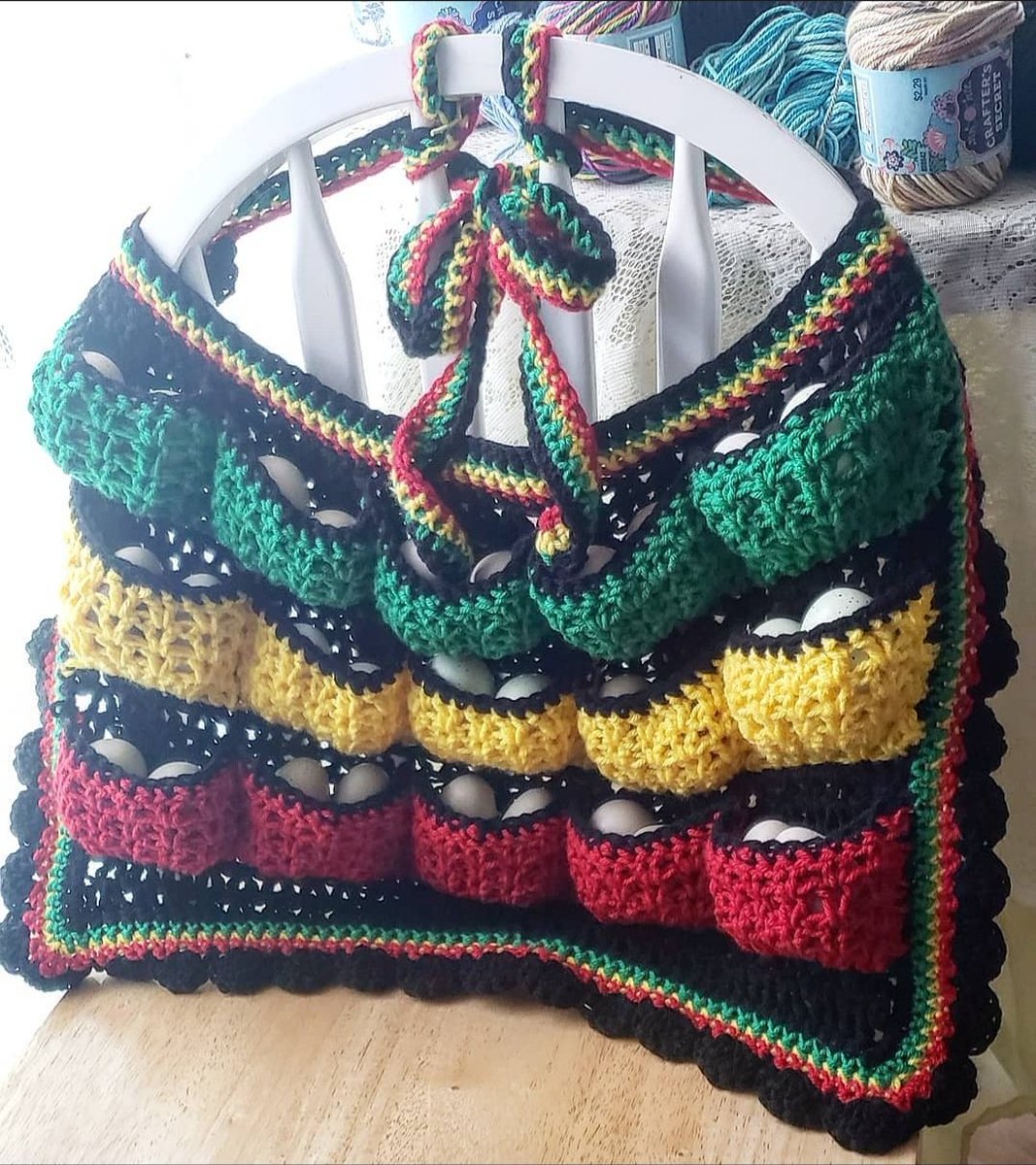 AlchemyCrochet's tweet photo. As a #chickenmom I ❤ to make a good #eggapron. They're so versatile, you can carry your 🥚s while doing chores around your waist or in a #messengerbag style. My FAV is the #rasta ❤💛💚Each pouch carries 2 large 🥚s or just 1, and the stretchy yarn hugs them safe n snug🐣🐤 https://t.co/B7Gm2FpR1v