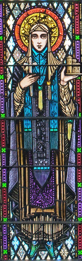 Note the Christian prayer still carries links to the PreChristian goddess with mention of her fire & of the sun. In ancient tales St Bridget’s association with fertility also included her carrying out abortions, too. Harry Clarke’s St Bridget in Ballinarobe (1924)