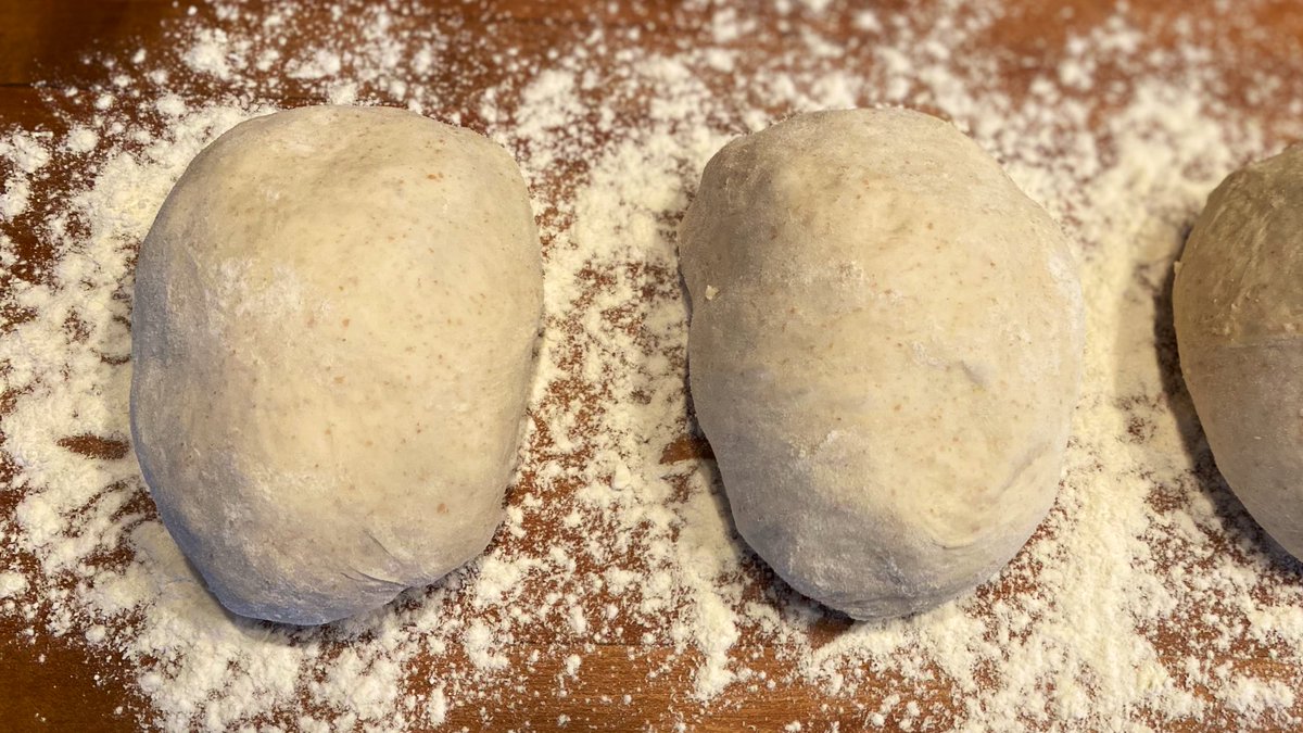 Take each 350g chunk and make little oblong balls like these. Stretch the top over and tuck the bottom underneath. Set them on the floured runway you made earlier, and re-use the plastic to cover so you feel less guilty. Save the remaining dough for next time. See?!