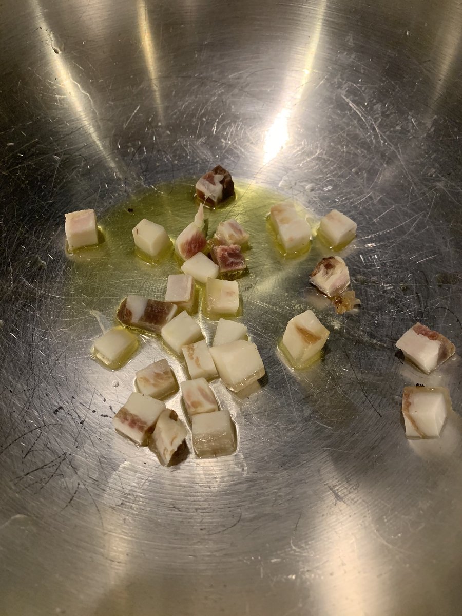 Now u cube up some frozen guanciale. I work w it frozen because it’s easier to cut that way. Cut off the hard skin portion. You can get guanciale from Amazon if you’re living in a barbarian area. Otherwise you can use pancetta but it’s not as good. Cook on low heat w some OO