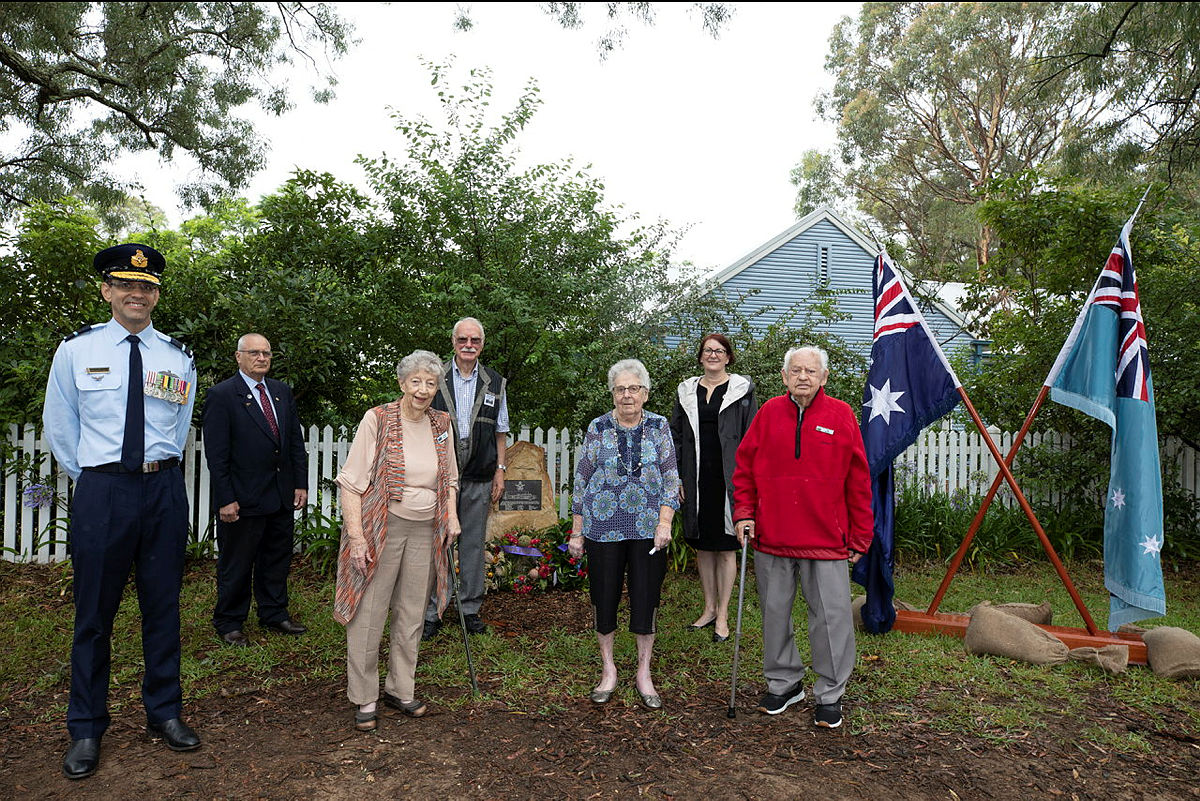Pam Thompson (3rd from right), who witnessed the crash as a 12yo, spoke at the ceremony. Also present was Tim Miers (right, in red), who saw the crash as an 11yo and helped recover the debris.