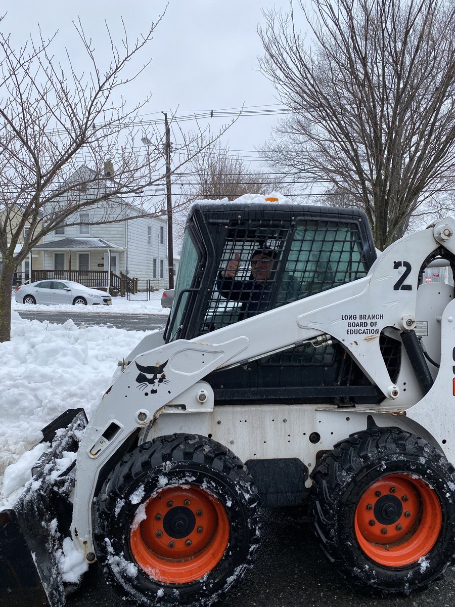 Rozza in the Bobcat cleaning up Gregory School!
