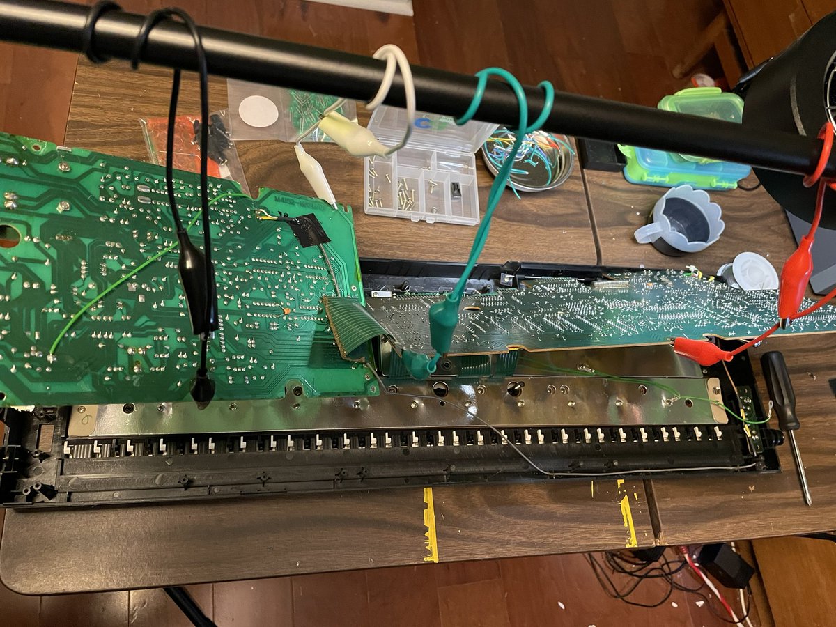 Getting kinky and suspending the first layer of boards to make this easier to work on.Stole this idea from the guy who made the mod kit, my only addition is using a mic stand to suspend them from.That brown connector is what we’re after for the display.