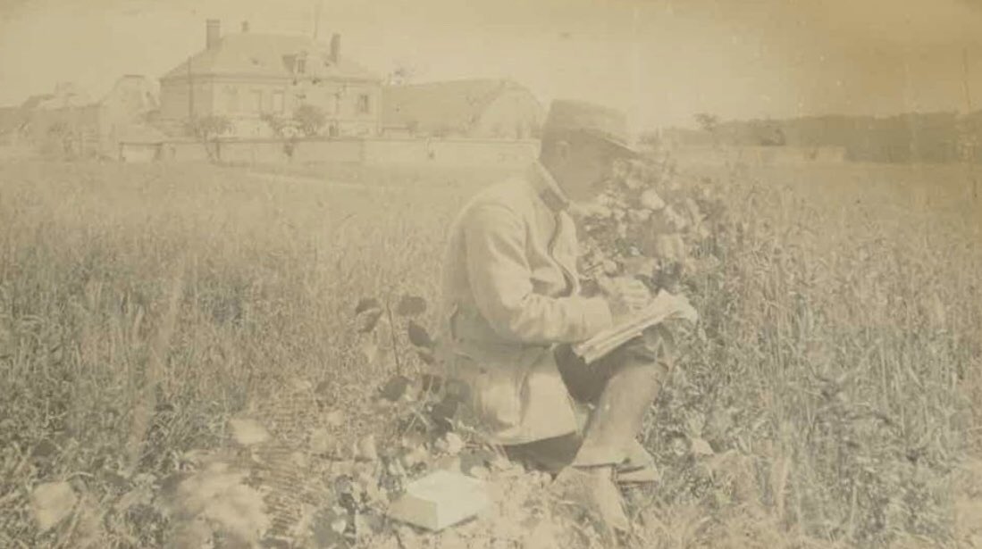 An Army doctor takes notes in a field.