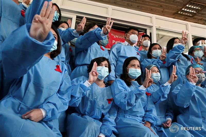 Medics at Yangon General Hospital protest against Myanmar's coup with the three-finger salute that has also become a symbol of opposition to authoritarian rule in Thailand. #WhatsHappeningInMyanmar