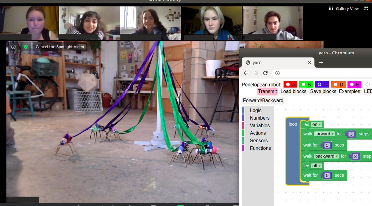 Row of people in zoom video windows along the top, with 8 robots arranged around a maypole in our studio in Penryn. Robot programming interface to one side with an example program to make the robot dance.