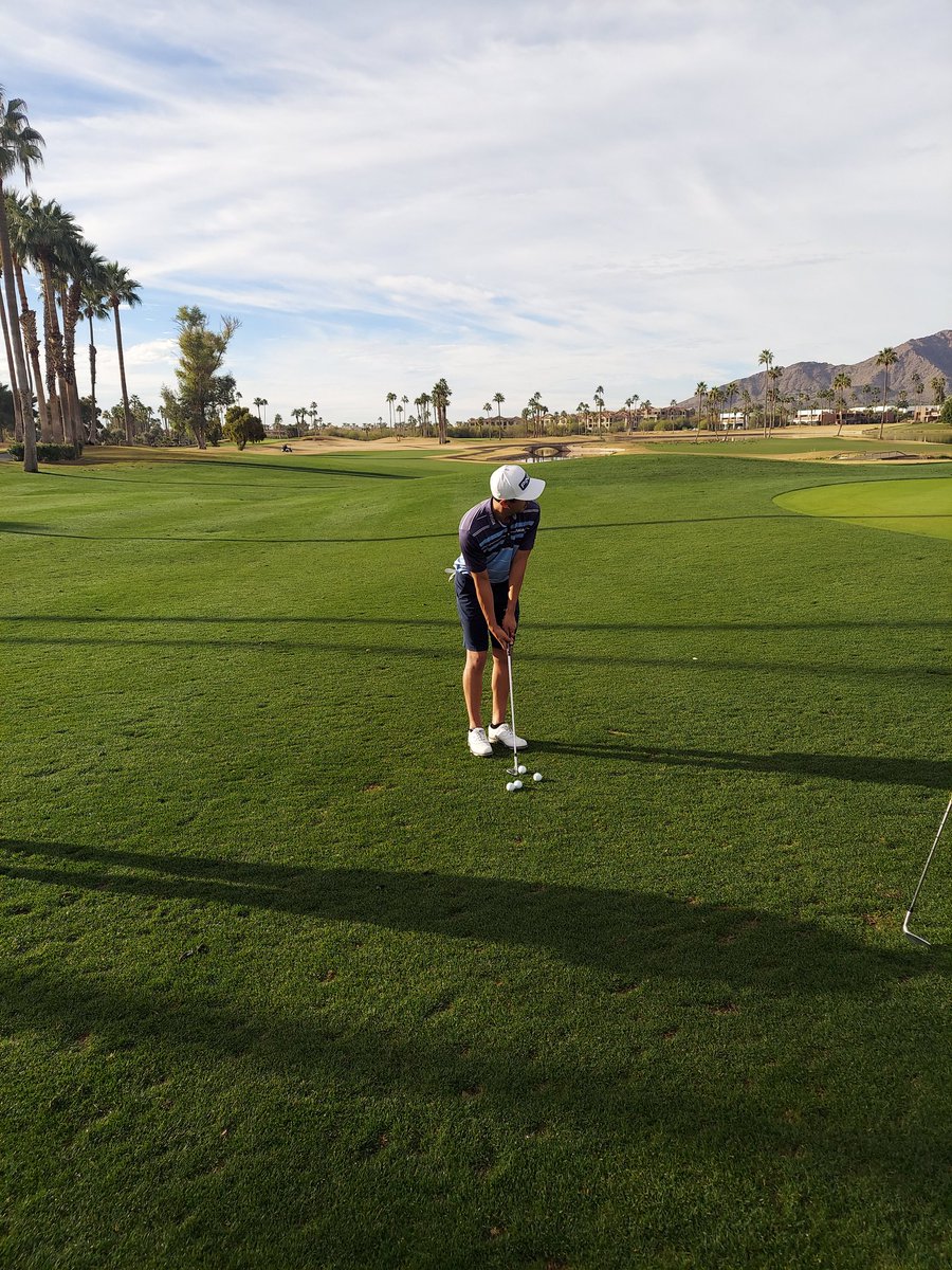 The wait:Vince Whaley and his caddie waiting for last few groups to come in to see if his -8 would be good enough. Anguiano who finished day before was chipping while waiting.