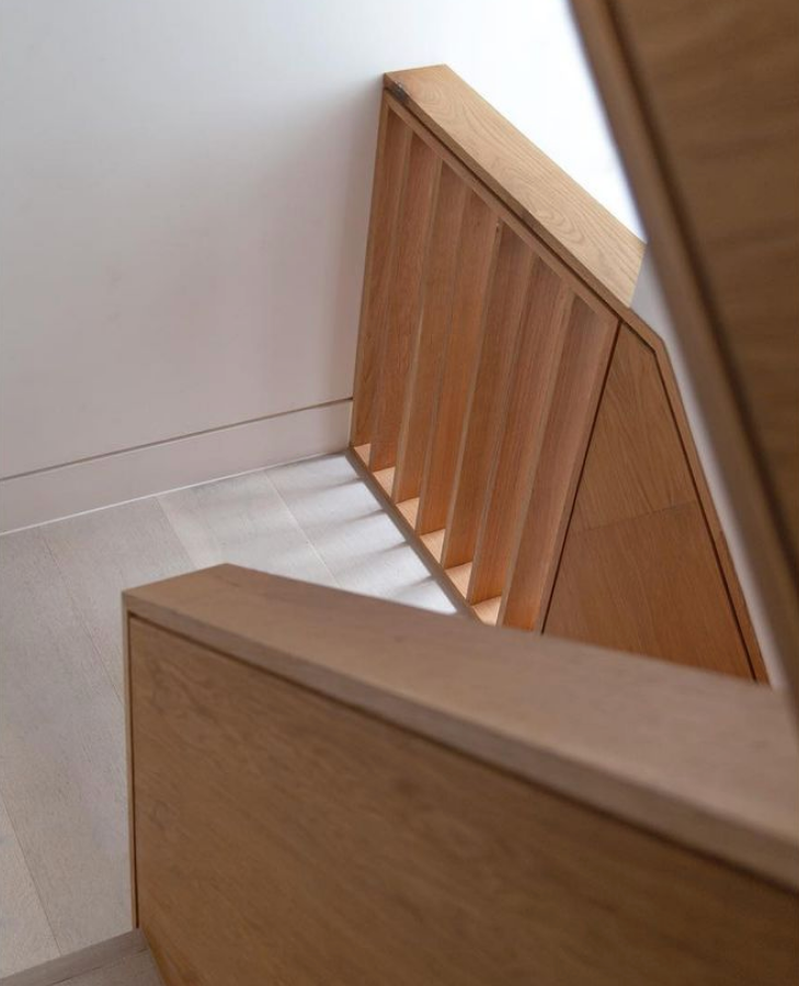 An impressive structured staircase design by @studiomcw acts as an anchor for The Void House, spanning the double and triple height spaces of the property. The design features a combination of Oak and Douglas Fir board detailing.