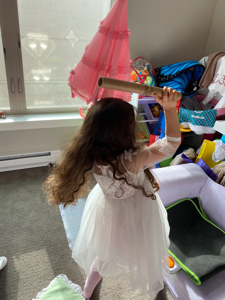 1fatbutt's tweet photo. Dear @gailcarriger, do "Finishing Schools" exist on Zoom? Walked in on this one fighting off robots with her parasol (&amp; paper towel roll). Want to fine-tune her skills. https://t.co/e6Ia1tIxad