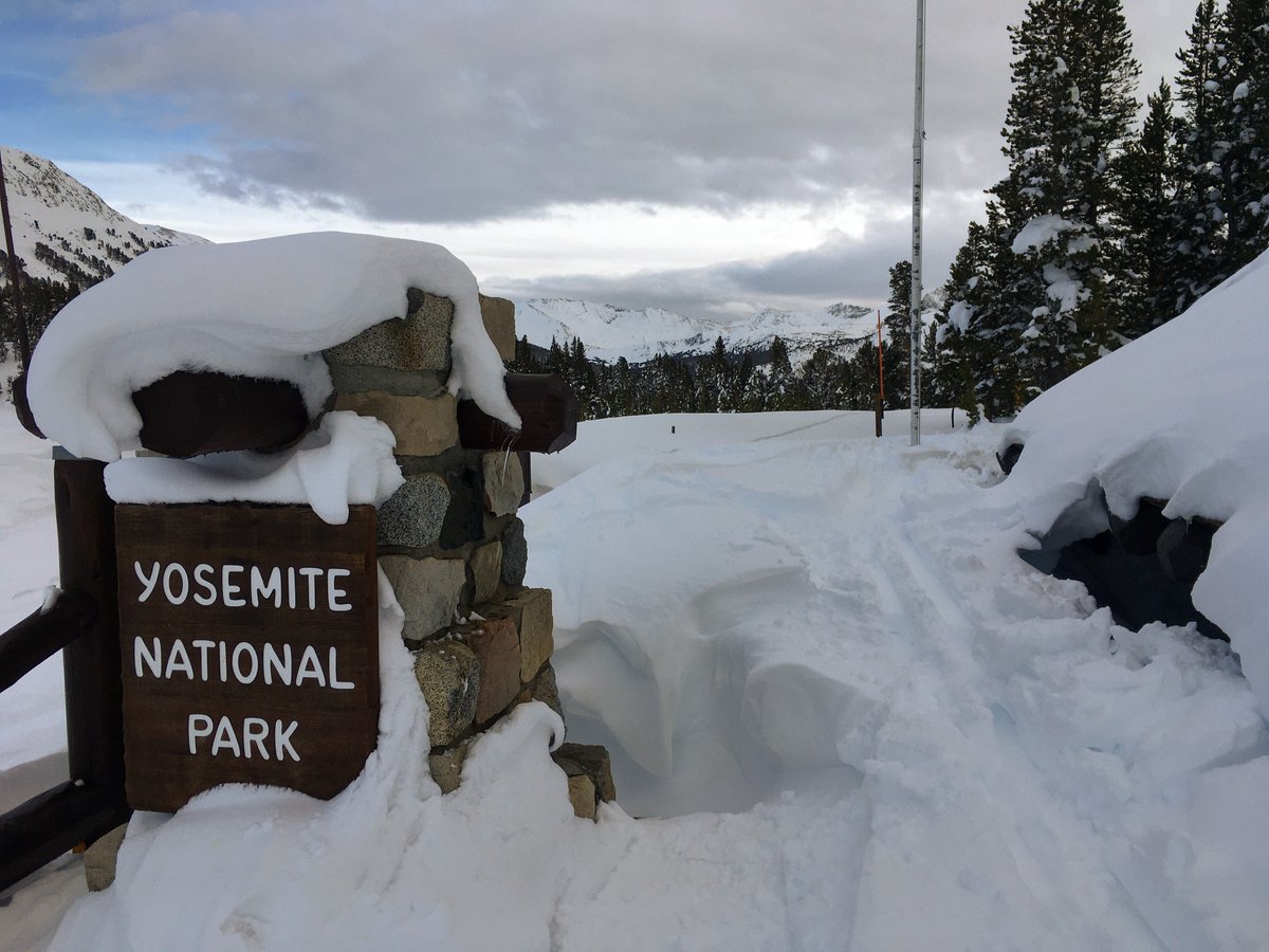 Almost snowed in Yosemite National Park entrance sign at Tioga Pass