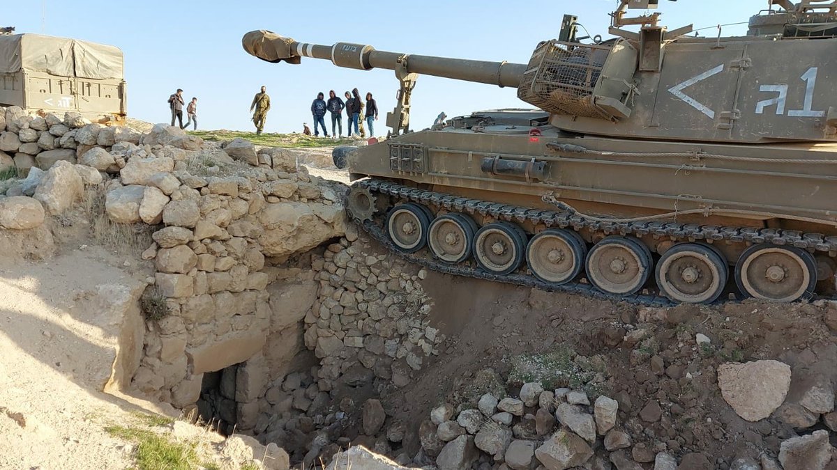 3. They passed next to the school and the clinic, dozens of vehicles and hundreds of soldiers waking up the village early in the morning. One of the mobile cannons got stuck over a cave that is used as a garage by one the families.