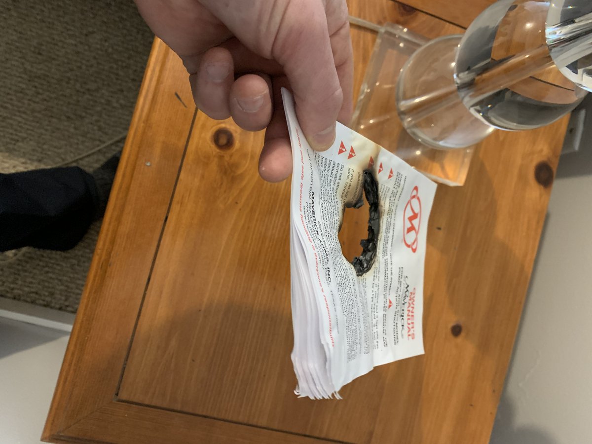 The base of the lamp is constructed of several stacked, clear spheres. Every indication suggests that when the sun shone through the bedroom window, one of the spheres focused the rays into a beam (the "magnifying-glass" effect) that eventually caused the paper to burn!